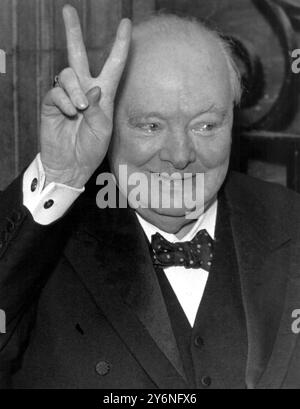 Sir Winston Churchill gives his well-known 'V' sign as he arrives back at number 10 Downing Street from Westminster where he attended the State Opening of Parliament and ceremonies  marking his 80th Birthday 30th November 1954 Stock Photo