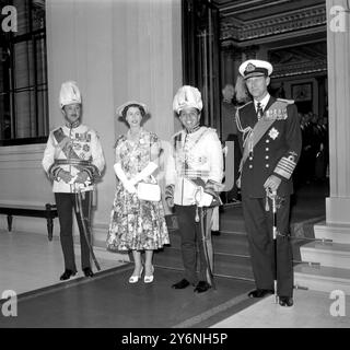 London: Posing for formal photgraph in the forecourt of Buckinham Palace are left to right:- The Crown Prince Abdal Ilah, The former Regent and Uncle of King Feisal; Queen Elizabeth; King Feisal of Iraq and the Duke of Edenburgh. King Feisal is in England on a State visit and had driven from Victoria Station in an open Landau with the Queen. King Feisal, who is 21, will also have diplomatic conversations with Premier Eden. 16 July 1956 Stock Photo