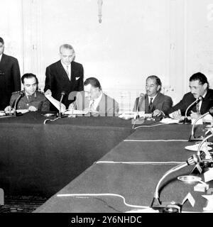 Cairo, UAR: United Arab Republic President Gamal Abdel Nasser leads the signing of a 23-page document containing the basic principles of a constitution and National Charter for a new Arab Federation comprising Egypt, Syria and Iraq, in the Presidential Palace here last night. Other signatories were General Louay El Attassi (left), chairman of Syrian National Revolutionary Council, and Ahmad Hassan El-Bakr (second from right), The Iraqi Premier. Extreme right is Field Marshal Abdel Hakim Amer, Egypt's Cheif Staff. The signing of the document ended 10 days of intensive negotiations by 30 delegat Stock Photo