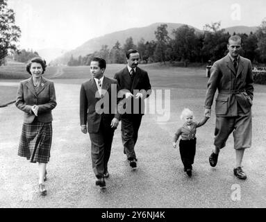 Balmoral, Scotland; A happy, informal picture as The Queen and the Duke of Edinburgh, with Princess Ann - striding along confidently - accompany 17- years old King Feisal of Iraq and his Uncle, Emir Abdul Illah, the Pdrince Regent, through the grounds of Balmoral Castle, where the boy king, an ex-Harrow schoolboy, is the guest of the Queen and the Duke. 26 September 1952 Stock Photo