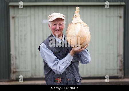 Peter Glazebrook holds a giant onion ahead of the UK national giant ...