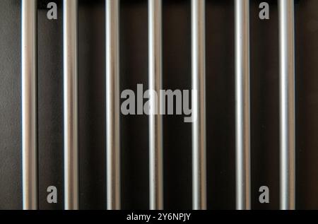 Shiny steel bars on a black background. Stock Photo