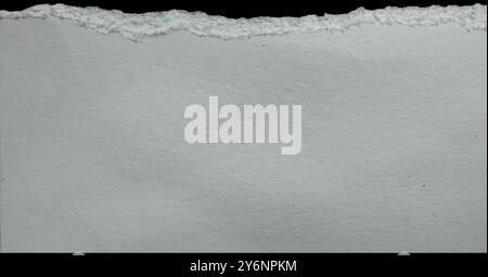 Piece of torn ripped blank paper. on black background isolated on white . Stock Photo