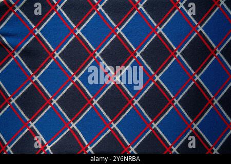 Blue, red and white geometric tartan panes rhombus checkered textile fabric for background. Top view. Stock Photo