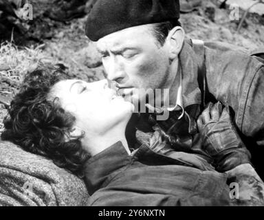 Hollywood: Gregory Peck leans fforward to kiss Ava Gardener in a scene from 'Snows Of Kilimanjaro'. 24 August 1952 Stock Photo