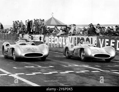 Argentinian Driver Juan Fangio (number L8) amd German Driver Karl Kling (20), drive their Mercedes Cars Close together during the final laps of the Grand Prix of France. So completly did the Mercedes Cars overcome the opposition that the drivers finished together, Fangio being the winner by one tenth of a second. The winning average speed, a record, was 115.596 M.P.H. it was the Mercedes Benz Firm's first post war appearance in Grand Prix motor racing. 5 July 1954 Stock Photo