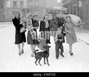 Bill Martin is home from the jungles of Burma: A family greeting for Private Bill Martin. with his mother, four sisters and young relations joining in the welcome home from Burma. 11 January 1945 Stock Photo