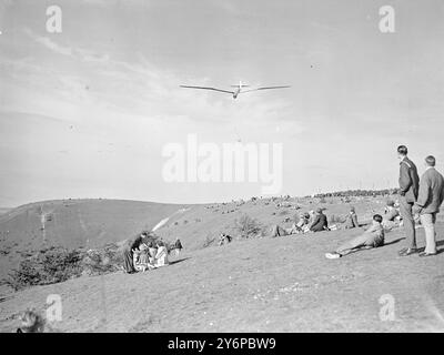 REST - AND ZEST .   Life has its ups and downs- particularly in the region of Dunstable, Beds, where in October sunshine - sightseers lounge gracefully on the grass while a London gliding club expert entertains them in the air with air- level runs and high level aerobatics.  October 3 1949 Stock Photo