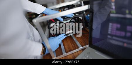 Man mechanic installing cooler fan with copper tubes on computer processor Stock Photo