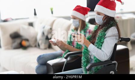 Young women playing video game for fun using controlling joystick Stock Photo