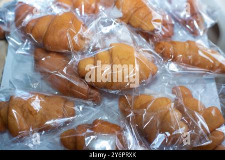 Freshly baked doughnuts packaged in transparent nylon for refreshment after a worship service in Church, Oyo, Nigeria on August 17, 2024. Stock Photo