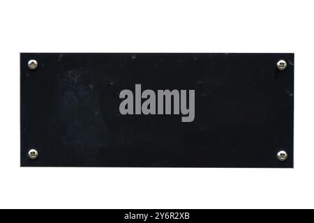 Distressed black steel plaque with a painted texture and screws cut out and isolated on a white background, signage stock photo image Stock Photo