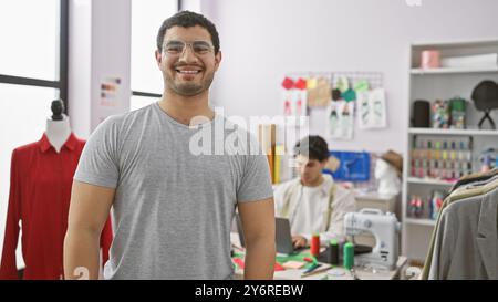 Two men engaging in tailoring work inside a bright atelier, surrounded by sewing equipment and garments. Stock Photo