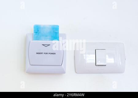 Using an electronic key card in a hotel room. Contactless card for access to premises and control system. Stock Photo