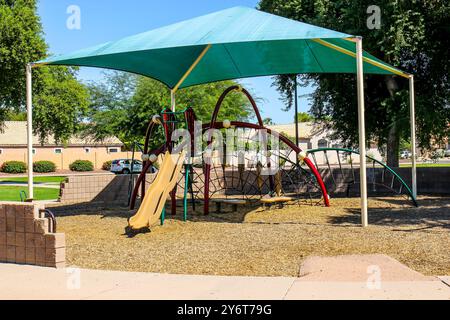 Children's Playground Equipment Under Blue Shade Canopy Stock Photo