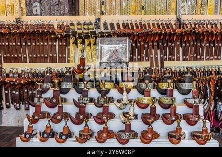 Belts and jambiya daggers for sale on a market in Najran, Saudi Arabia Stock Photo