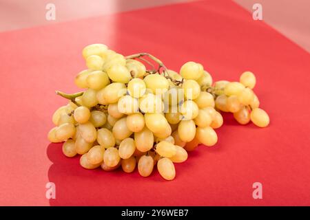Fresh Green Grapes: Juicy Bunch of Sweet Table Grapes on Pale Yellow Background - Healthy Snack, Organic Produce, and Natural Fruit Photography Stock Photo