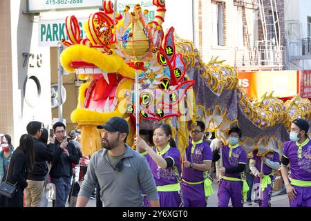 San Francisco, CA - Feb 24, 2024: Lion dancers walking up and down the main streets in  Chinatown for Lunar New Year festivities. Stock Photo