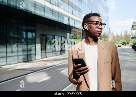 Young Black Man Listening To Music On Way To Work Stock Photo