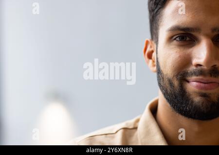 Smiling man with beard looking at camera, close-up portrait in studio, copy space Stock Photo
