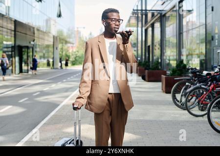 Young Businessman Recording Voice Message Stock Photo