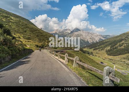 A motorcycle rides on the Spluegen pass road, Canton of Grisons, Switzerland Stock Photo