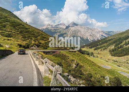 A car drives on the Spluegen pass road, Canton of Grisons, Switzerland Stock Photo