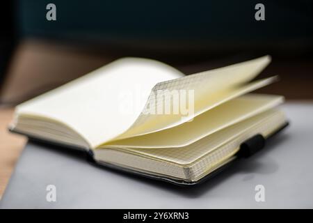 Close-up of an open notebook with grid paper pages, perfect for note-taking or sketching. Stock Photo