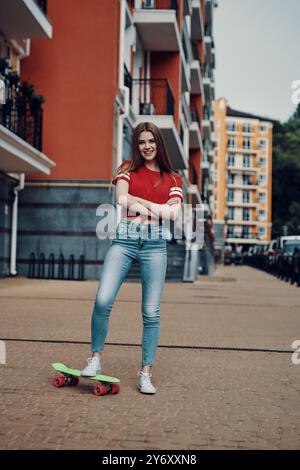 Her favorite mode of transport. Full length of attractive young woman smiling and looking at camera while standing outdoors Stock Photo