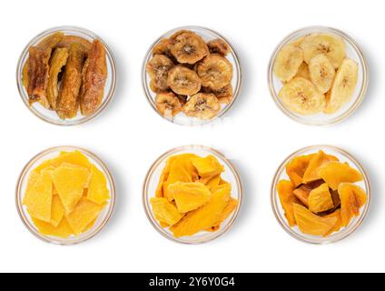 Assorted dried mango and banana slices and bites on white background.Top view. Stock Photo