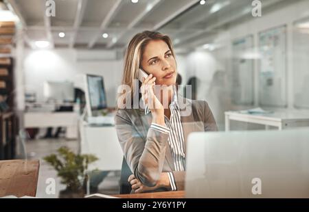 Businesswoman, laptop or phone call in office for thinking of planning, appointment or speaking. Idea, discussion or female manager talking on mobile Stock Photo