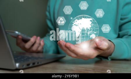 A person holding a digital globe with various technology icons, symbolizing global connectivity and digital transformation. Stock Photo
