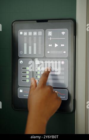 Adjusting Settings on Smart Home Control Panel Stock Photo
