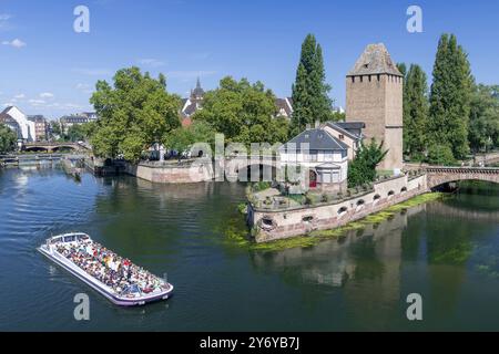 Strasbourg, France - The Ponts couverts, three bridges and four towers erected on the River Ill seen from the Barrage Vauban with a boat on the river. Stock Photo