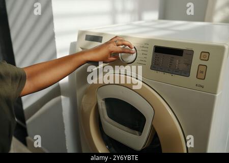 Adjusting Settings on Modern Washing Machine Stock Photo