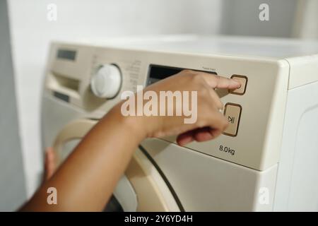 Adjusting Settings on Modern Washing Machine Stock Photo