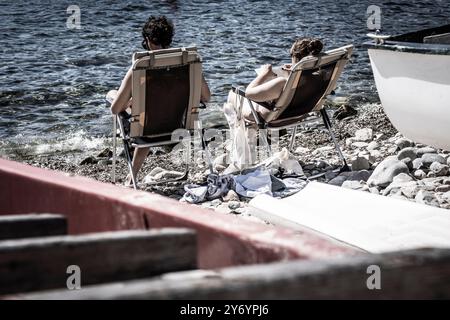 reading on the beach, Cala S'Alguer, Palamós, Girona, Catalonia, Spain Stock Photo