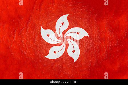 The Hong Kong flag depicts a white stylized orchid flower with five stars on a red background with a texture reminiscent of watercolor Stock Photo