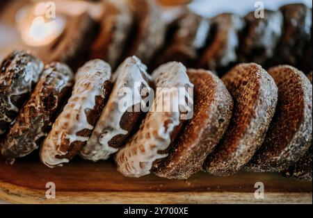 close up of stack of chocolate frosted donuts on a table Stock Photo