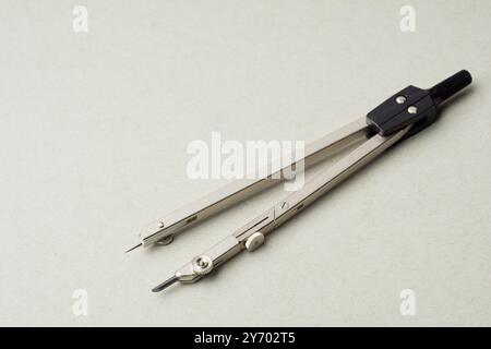 Compass on a white background. Drawing tools. Close-up. copy space Stock Photo