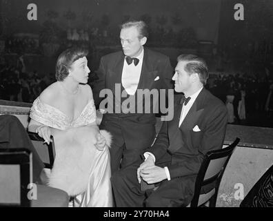 THREE-WAY CHAT AT THE FILM BALL   Actors , actresses , directors, producers and other film personalities from both sides of the Atlantic had a ' night out ' together at the annual Film Ball , held in the Royal Albert Hall , London .   The Function was on aid of the Cinematograph Trace Benevolent Trade .     PICTURE SHOWS:- Actress GOOGIE WITHERS and her actor-husband JOHN McCALLUM ( right) have a friendly meeting with ' tough ' American actor RICHARD WIDMARK .  September 22 1949 Stock Photo