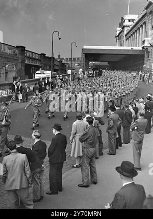 GUARDS HOME FROM MALAYA   The 3rd Battalion Grenadian guards, the first unit of the guards Brigade to return home from Malaya , reach Waterloo station, London today from Southampton where they arrived yesterday aboard the troopship ' Dalawara ' . On leaving the station the troops marched along York Road, Lambeth Palace Road, Vauxhall Bridge and Grosvenor road en route for Chelsea barracks where they will be quartered .   The battalion left for Malaya last August after only four months service in England from the date of disembarkation from Palestine.    PICTURE SHOWS:- People line the pavement Stock Photo