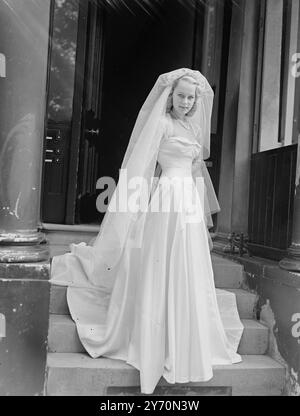 MOTHER MADE PATTI'S WEDDING DRESS   Wearing a wedding gown made her by her mother 20-year-old Patty Morgan, Australian actress, who tomorrow is to become the bride of Mr. Victor Sylvester, son of Victor Sylvester, the dance band leader and teacher of dancing, at St Mark's Church, North Audley Street, London.  The gown is of white slipper satin, Ms Morgan says that all her clothes are made by her mother- Miss. Irene  Morgan, from Sydney, Australia.  The bride-to-be was one of Australia's most popular camera models before she came to Britain in 1946.she made her screen debut in ' Idol of Paris ' Stock Photo