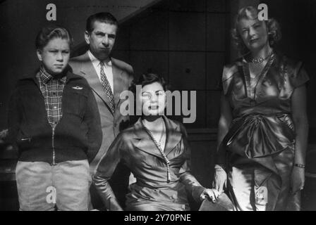 Soraya Esfandayiari , fiancee of the Shah of Iran , photographed in a family group (seated forefront) after her  recent illness which caused the postponement of the wedding , scheduled to take place today , 27 December 1950 . LtoR Soroya's young brother , Bijan , her father , Soroya , and her mother , Eva , who is German born .27 December 1950 Stock Photo