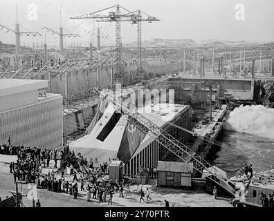 ASWAN HIGH DAM CELEBRATIONS ASWAN, EGYPT ;  The flags of the united Arab Republic and Russia fly from a crane during celebrations here recently to mark the eighth anniversary of the start of work on the £320 million project which will double the electricity resources of the country, and also the first official operation of the first four giant turbines.  Soviet technicians have played a big part in contrstucting the Dam and its power station.  28 January 1968 Stock Photo