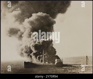 THE END OF A U-BOAT VICTIM.PHOTO SHOWS:- A column of dense black smoke rising from the torpedoed French merchant vessel 'Emile Miguet' as she sinks into the Atlantic after being attacked by a German U-boat. The picture was made from the U.S. liner 'President Harding', which went to the French ship’s aid. The crew, however, had been rescued by another ship. Previously, the 'President Harding' had picked up two lifeboats bearing the complete crew of the British merchant vessel 'Heronspool', also victim of a submarine attack. 31 October 1939 Stock Photo