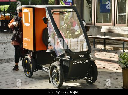 Pedal powered Omniva postal mail delivery EV vehicle Vok Bikes with storage for parcels, delivery in Old Town on cobblestone streets Tallinn, Estonia. Stock Photo