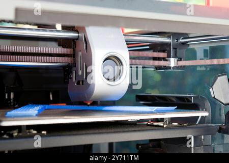 3d printing detail, making three dimensional objects from a digital file. A 3D printer extruder,  a filament feeding mechanism used in 3D printers. Stock Photo