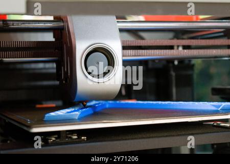 3d printing detail, making three dimensional objects from a digital file. A 3D printer extruder,  a filament feeding mechanism used in 3D printers. Stock Photo