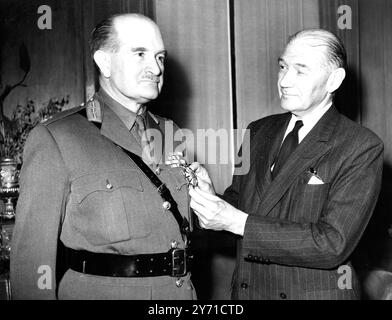 C.I.G.S. gets American Decoration for Burma Service.    Field Marshal, Sir William Slim, Chief of the Imperial General Staff, receiving from Mr Lewis Douglas, the American Ambassador, the decoration Chief Commander, Legion of Merit, at the Ambassador's residence in Princes Gate, Kensington, London, this evening. Field Marshal Slim recieved the award for meritorious service from Ocotber 1943 to May 1945, when he was Commander of the British 14th Army in Burma. 31 July 1950 Stock Photo